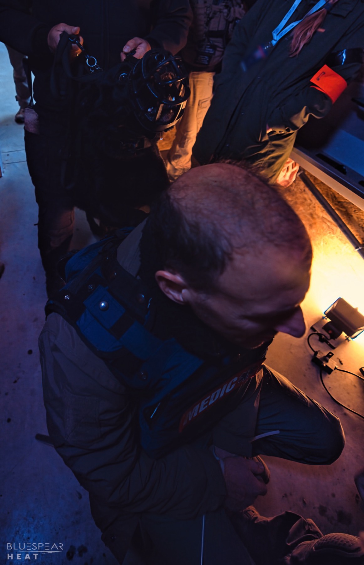 Medic kneeling beside casualty indoors